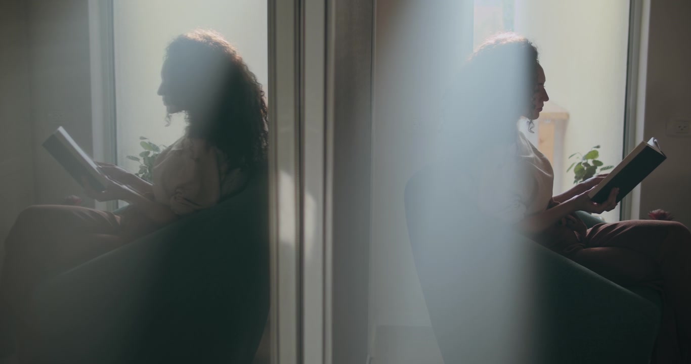 Reflection of a woman reading a book