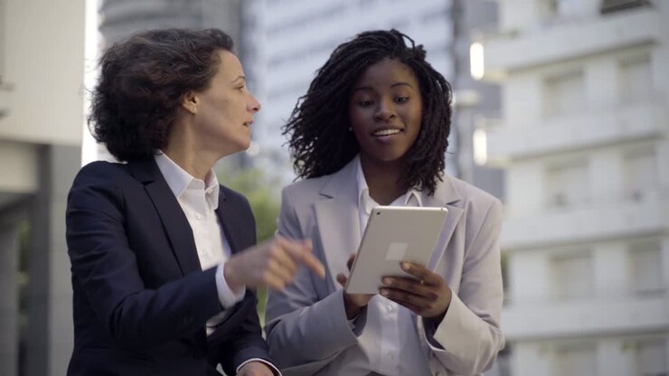 Emotional businesswomen with tablet pc outdoor