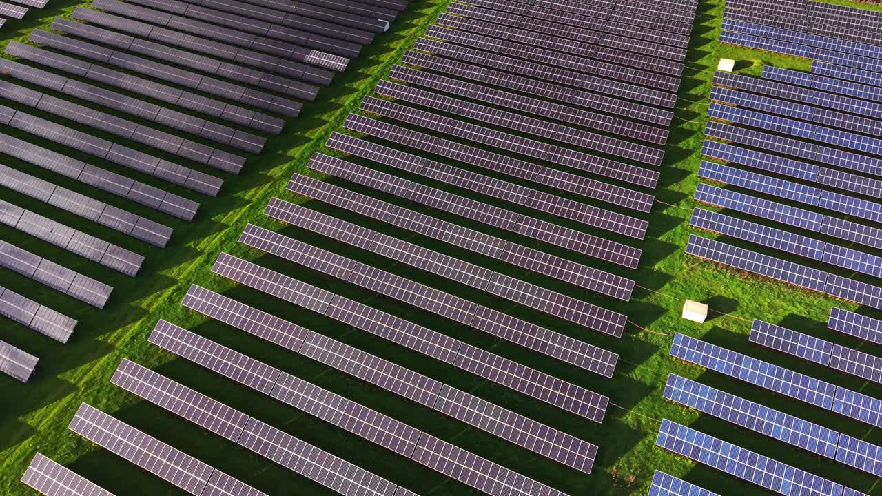 Solar panel field viewed from aerial perspective during bright day