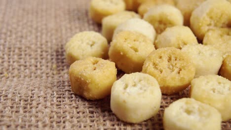 baked crispy croutons on a rustic burlap. bread rusks. macro