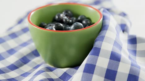 Blueberries-in-bowl-placed-on-checked-napkin-4K-4k