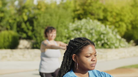 african-american woman doing squats and looking at camera