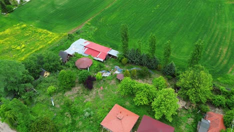 Aerial View of a Rural Landscape with Farmhouses and Green Fields