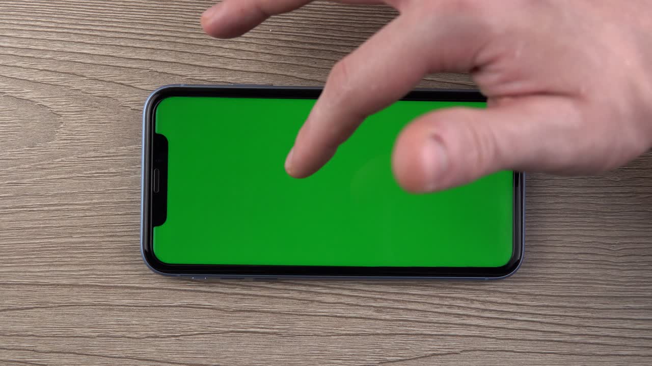Smartphone with green screen mockup swipe scroll gesture hand close up mobile