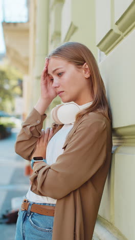 frustrated caucasian young woman thinking of money debt budget loss bankruptcy on urban city street