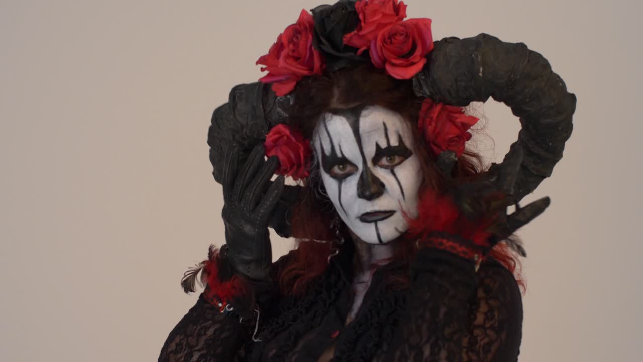 Catrina Cosplay girl moving her hands infront of her face and angelical eyes with a Light background, Medium close up
