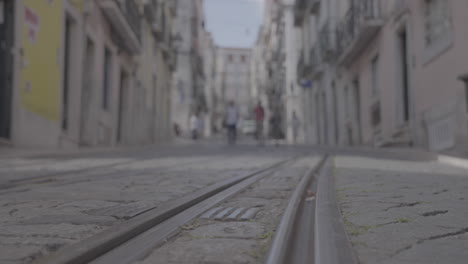 yellow tourist tram in the small streets of lisboa portugal log