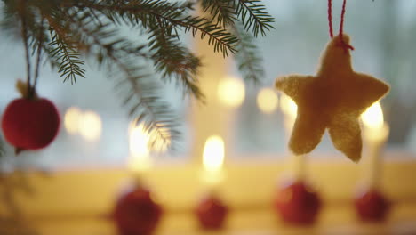 christmas decorations - wool star hangs on a christmas tree, sweden, close up