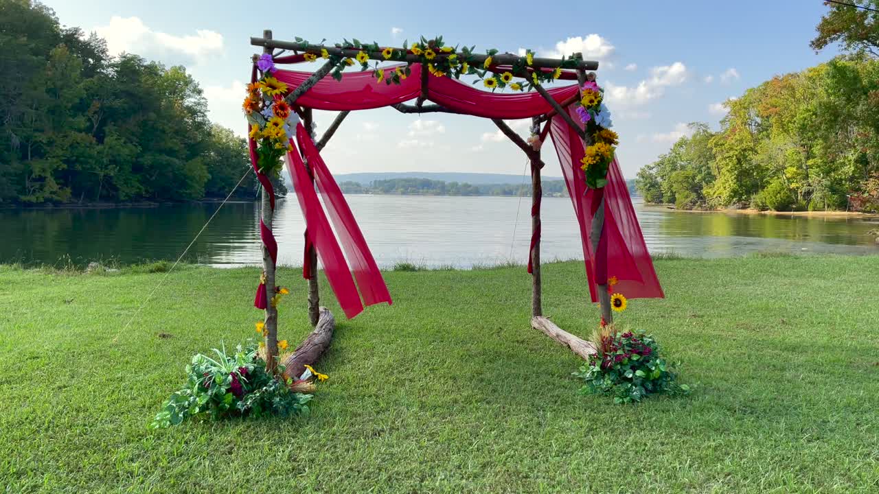 Tilt Up - Traditional Jewish Wedding Chuppah - Natural Wood with Red Cloth and Flowers - Summer Wedding By Lake - 4k