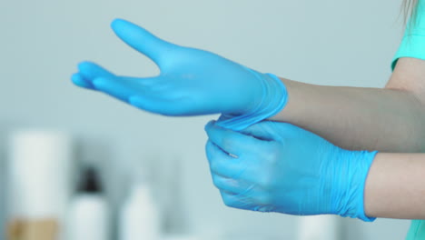 close-up of the doctor wearing rubber gloves