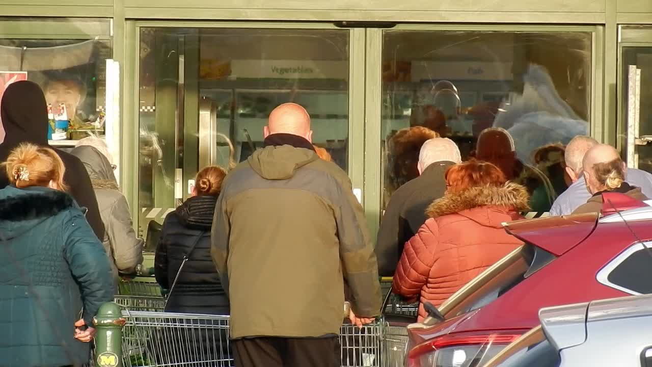 Cornona Covid virus shoppers panic buying waiting as store doors open UK retail