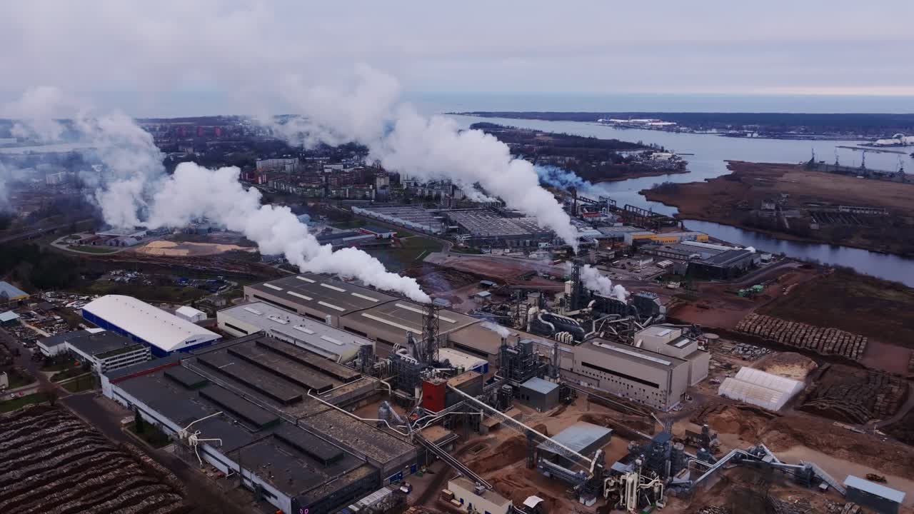 Heavy emissions rise over Latvian skyline reflecting global power imbalance
