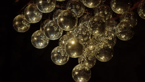 shiny mirror balls in darkness transition from gold to silver light