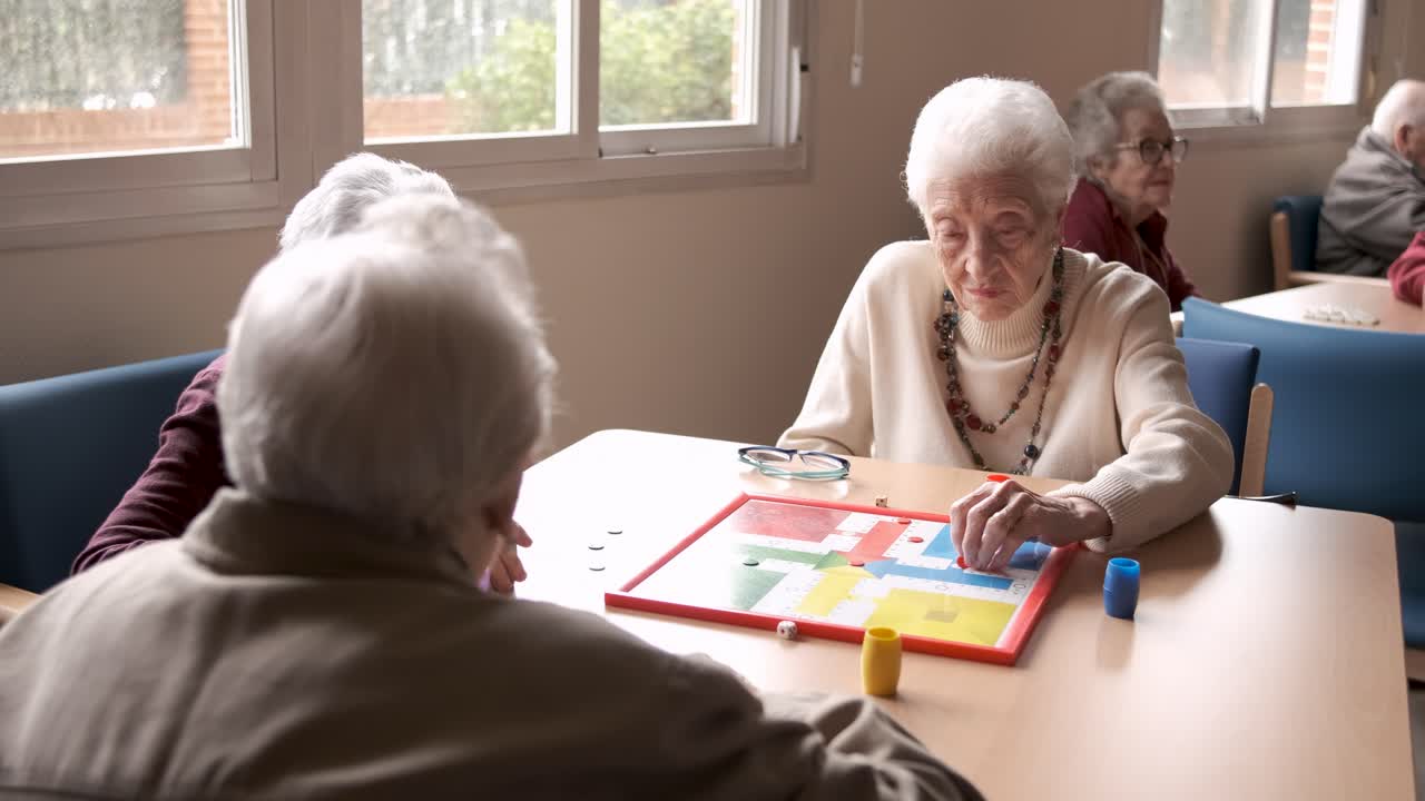 Senior people playing board game in retirement home