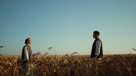 agricultural business partners concluding successful deal at golden wheat field.
