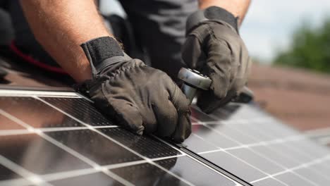 technician bolting solar panels together on roof for sustainable future