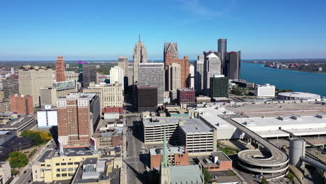 smooth backwards flying aerial shot of the detroit michigan skyline on a beautiful, clear and sunny day