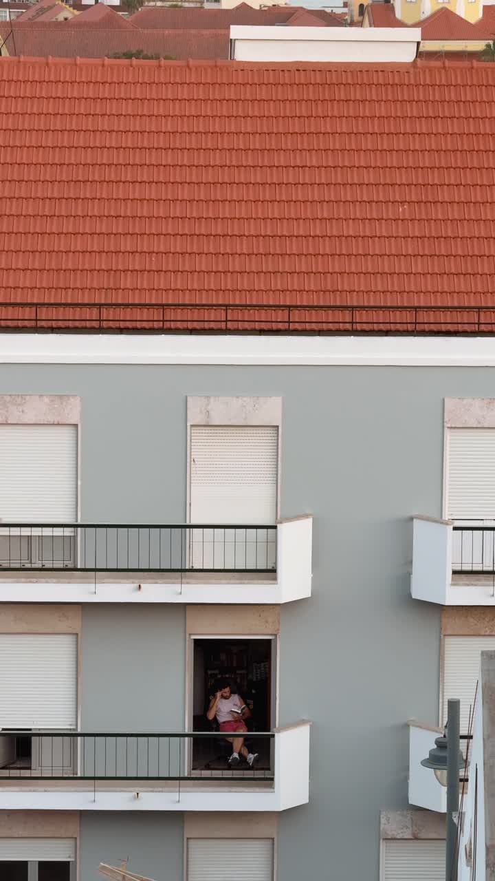 Building Facade with Balconies and Person