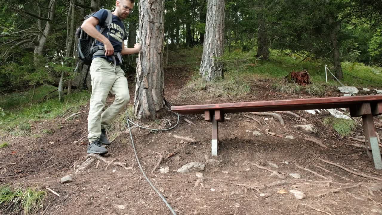 un hombre caminando por un bosque muy verde en un día nublado en eslovenia ubicado cerca del pueblo de gozd martuljek-1