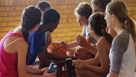 high school kids interacting while relaxing in the court