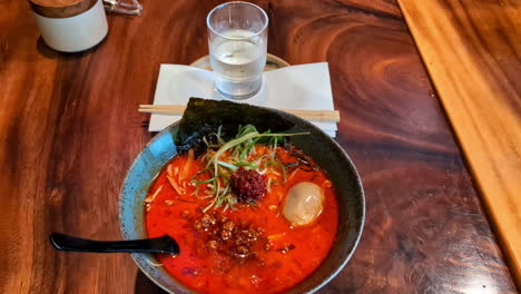 zoom in shot of a spicy red pad thai soup