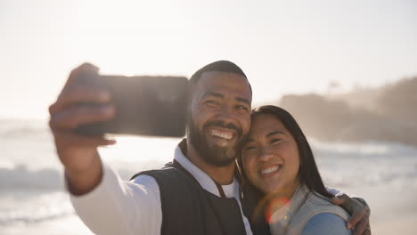 Couple,-selfie-and-happy-at-beach-for-vacation