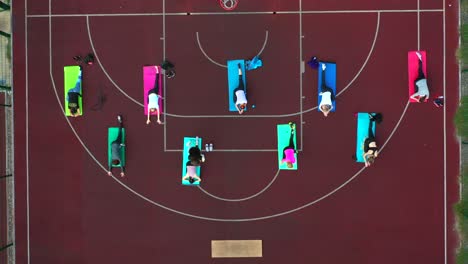 group outdoor fitness class on basketball court