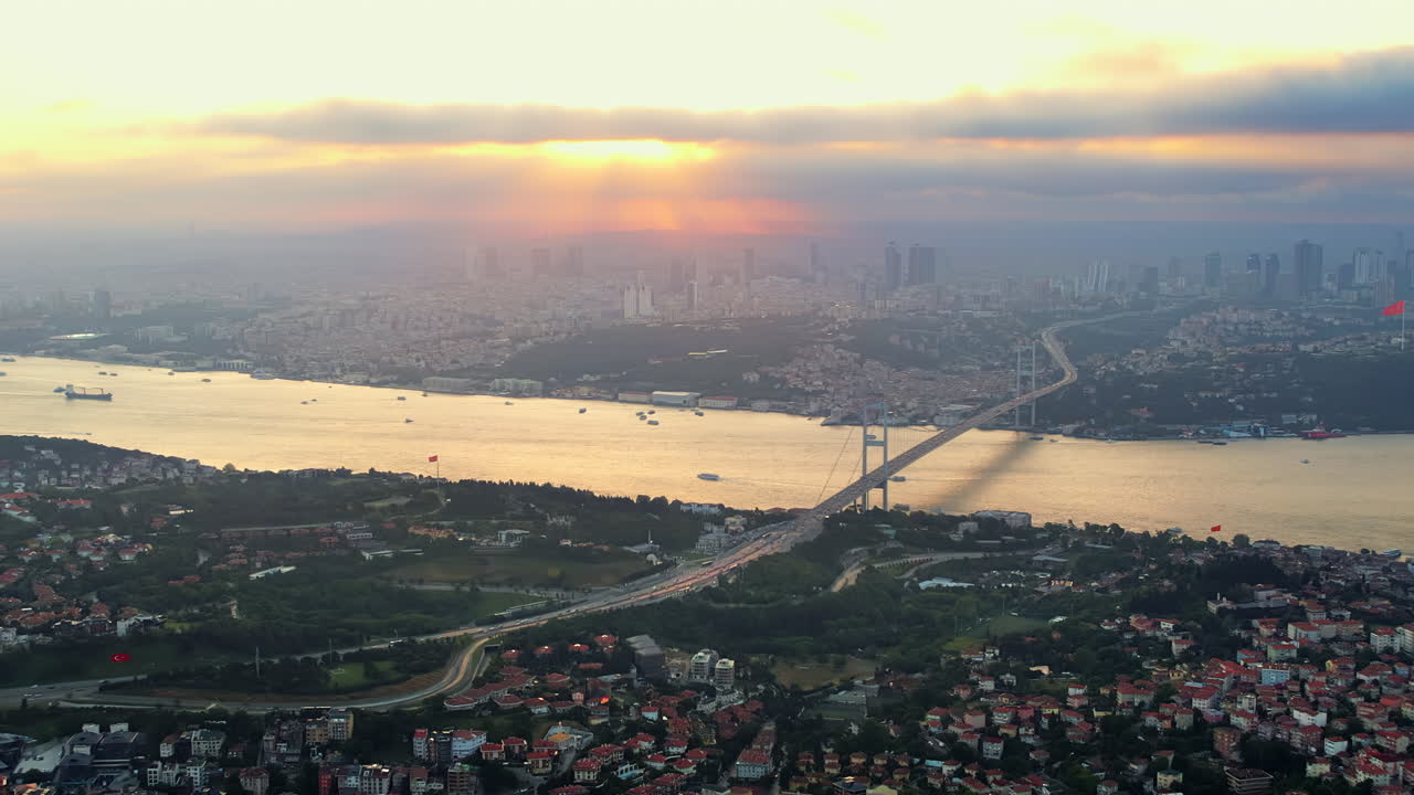 Aerial drone view of Istanbul at sunset, Turkey. Bosphorus strait over the strait with floating ships, multiple buildings,