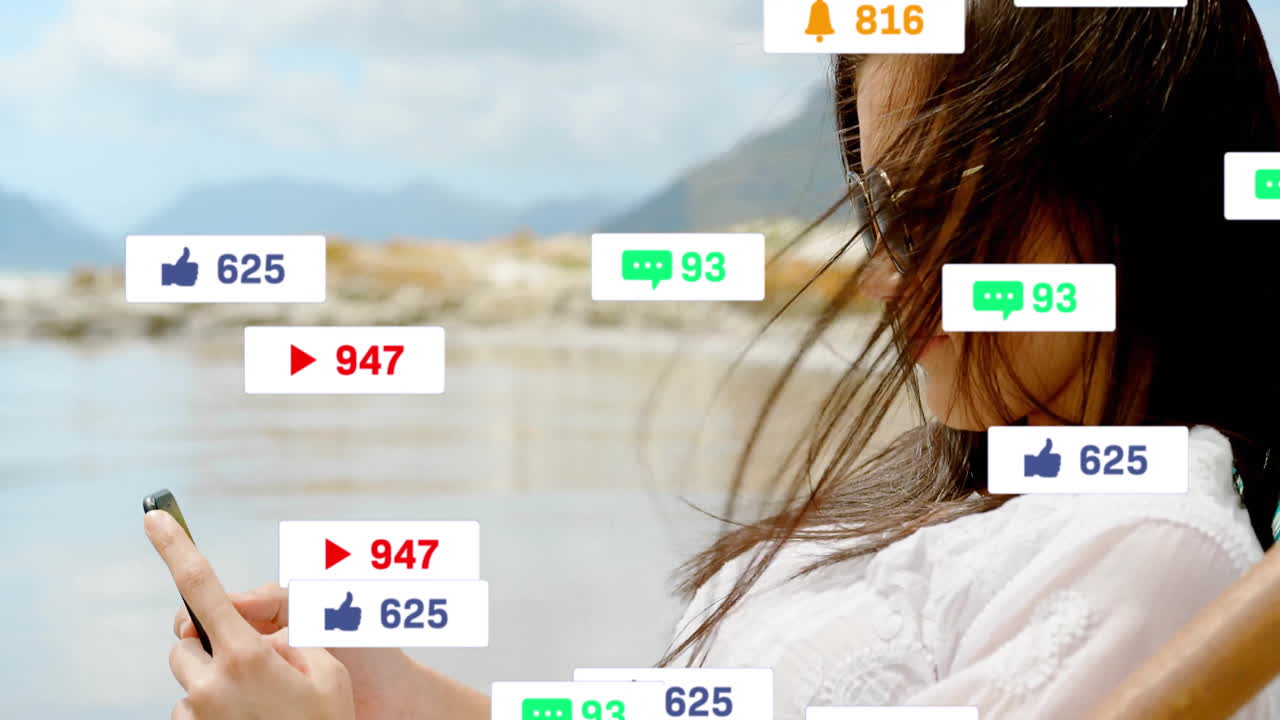 Woman using smartphone by lake, displaying floating social media notifications, technology focus