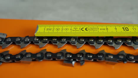 measuring chainsaw chain in the shop