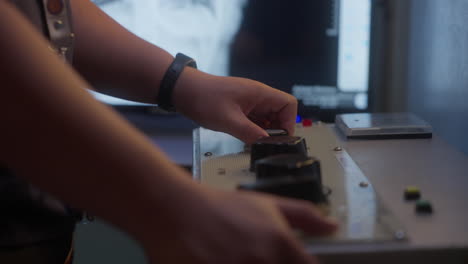 hands turning knobs of a machine. closeup