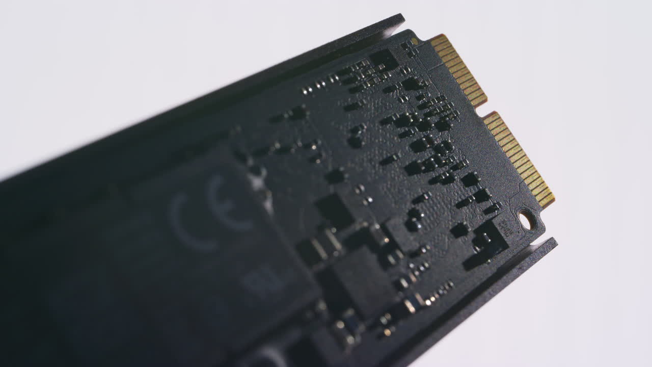 Cinematic macro shot of a dark SSD component with white background