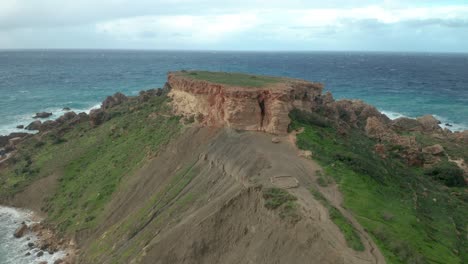 AERIAL:-Flying-Over-Il-Qarraba-Plateu-and-Greenery-on-a-Cloudy-Bright-Day-in-Winter