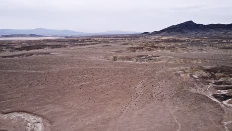 aerial drone view of a vast rocky desert landscape in california with dramatic terrain