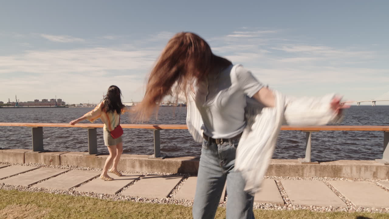 Joyful Women Partying on Waterfront in Summer