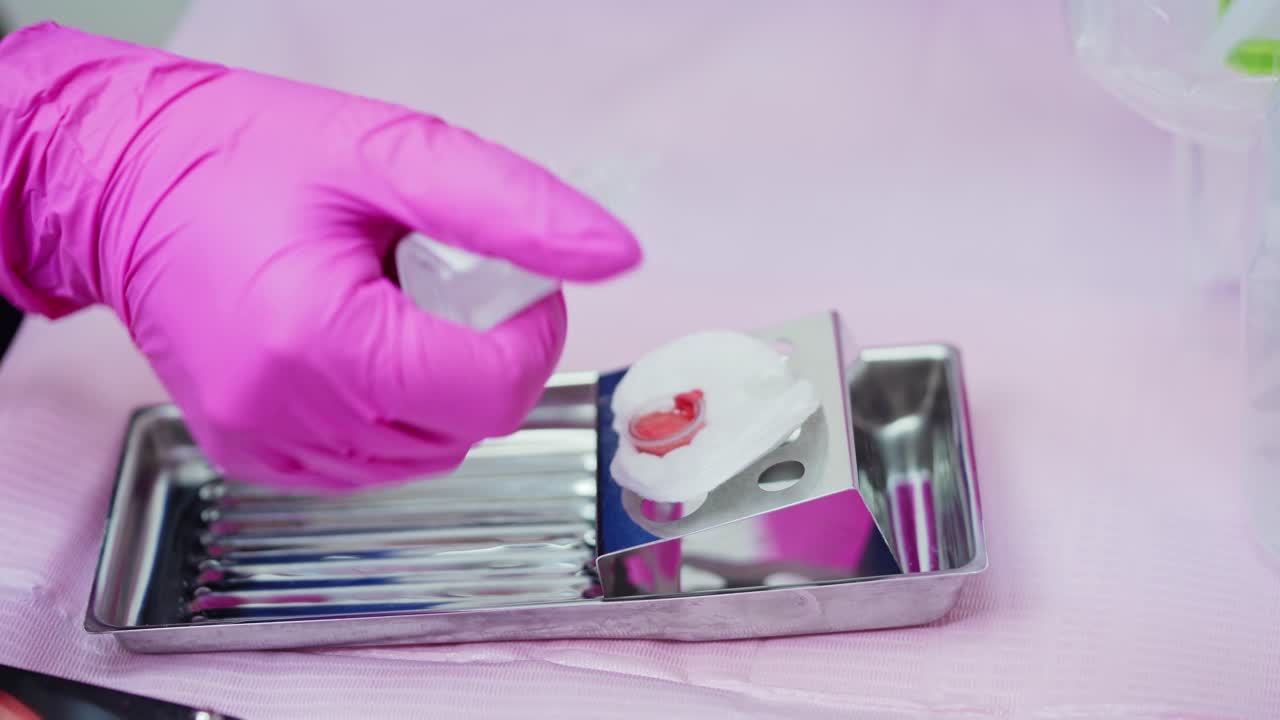 Beautician prepares color for micropigmentation. Medical equipment for permanent makeup on lips. Close-up.