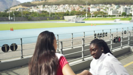 women relaxing and talking at a stadium