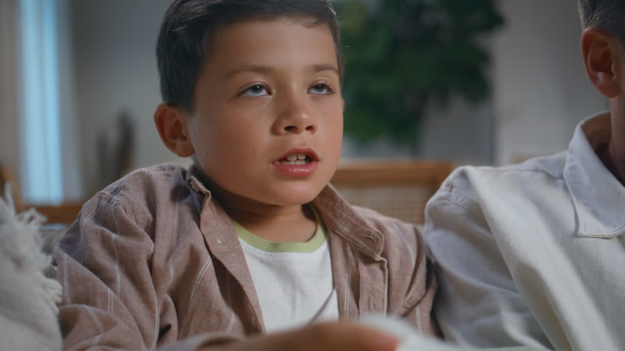 Little boy competing videogame late evening home closeup. Excited child playing