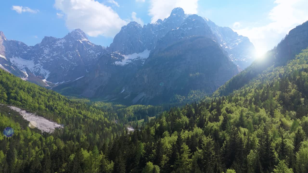 Drone ascending in front of towering peaks of Triglav national park, spring day