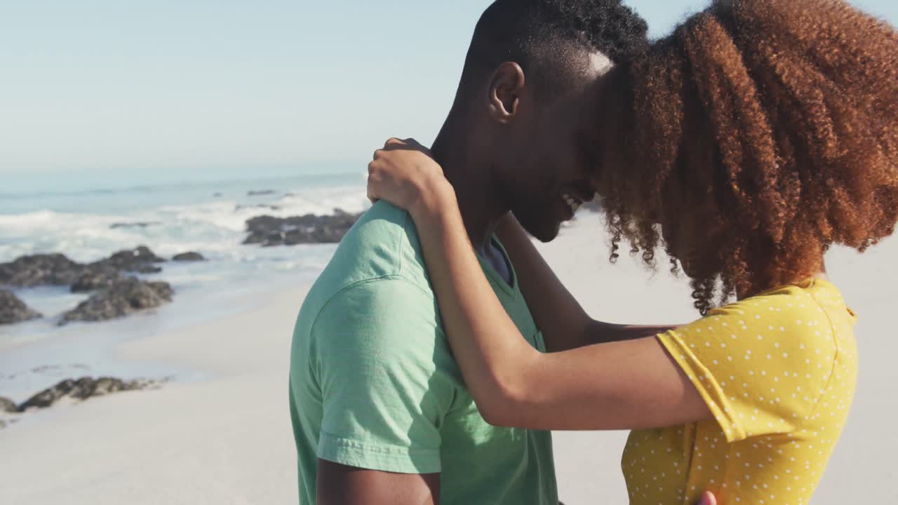 African American couple dancing seaside