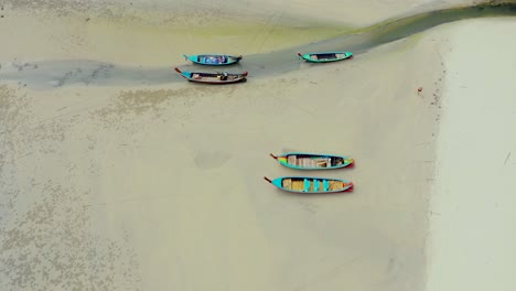 Aerial-view-or-top-view-of-long-tailed-boat-is-floating-on-the-emerald-sea