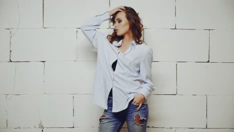 stylish wearing woman. young sexy woman posing in style clothes on background in studio