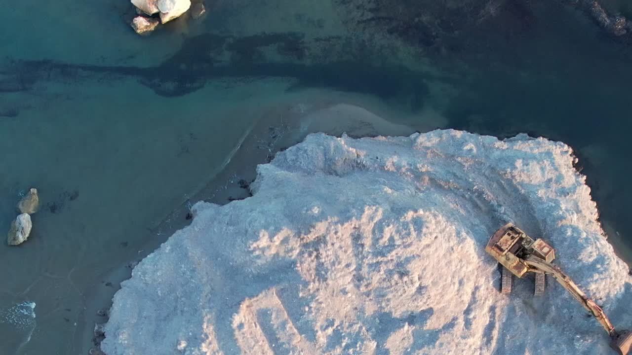 Aerial view of coastal rocks and water in Greece during sunset