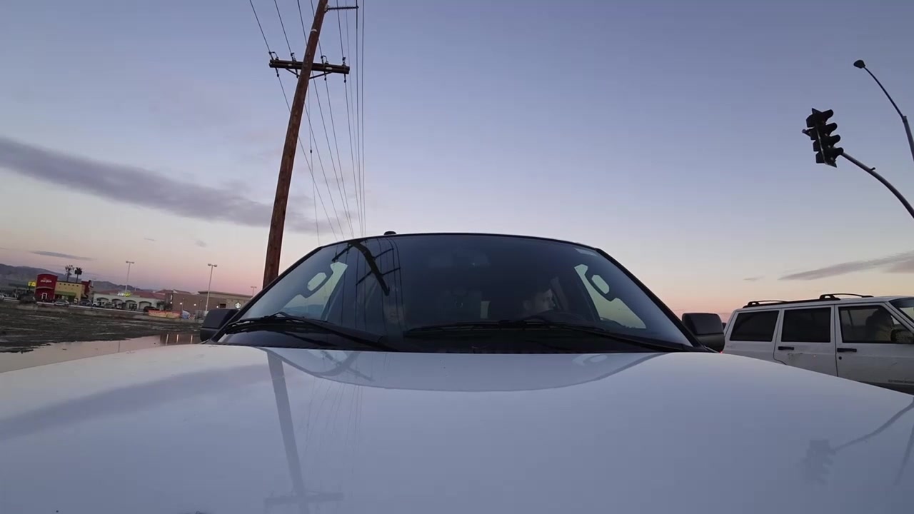 Timelapse of a car driving during sunset from a hood-mounted camera.