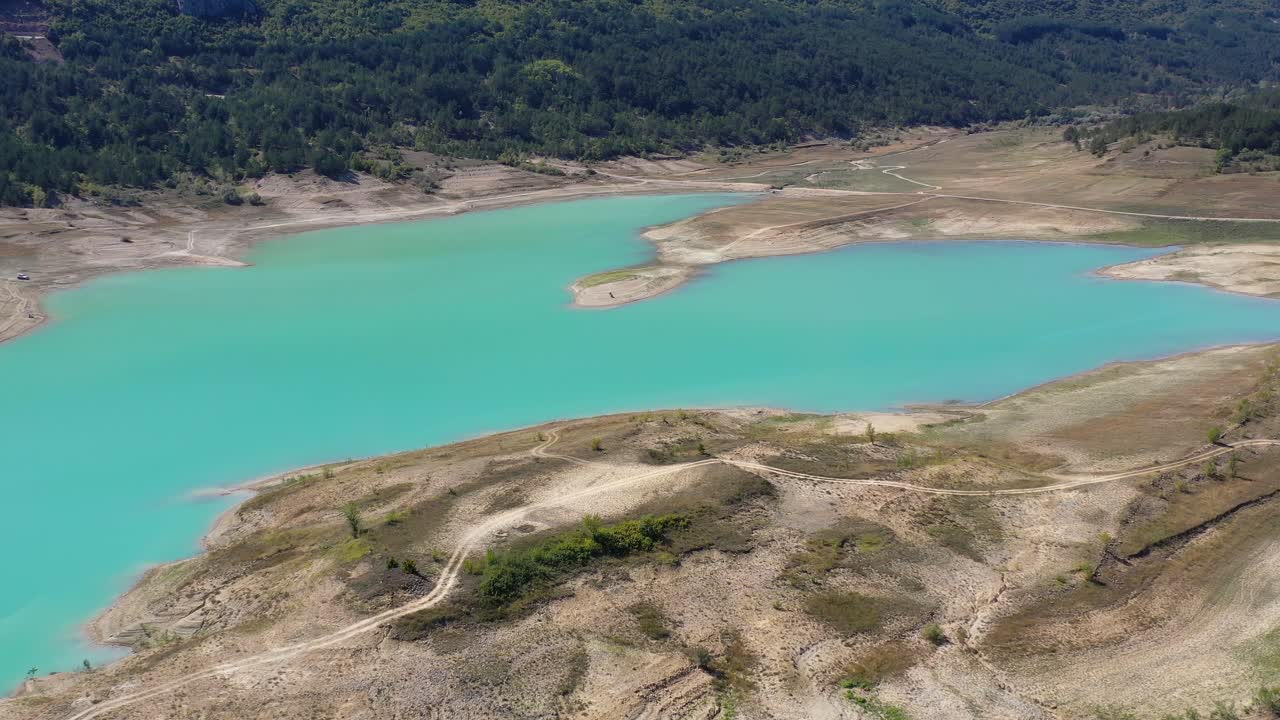 Rocky peninsula formation on Zeleno jezero reservoir lake in Croatia with low water level, Aerial dolly in shot