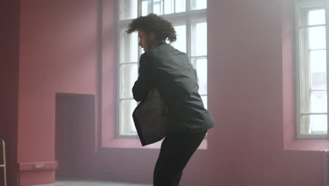 young man dancing in a classroom