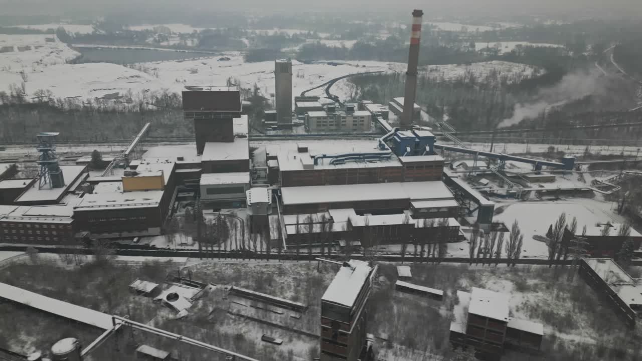 Drone reveal Karviná industrial coalmine in bleak frozen winter landscape