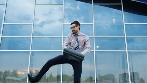 happy businessman jumping outside
