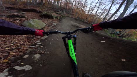 mtb rider pov jumping neat rock feature into berm corner pov fall trail