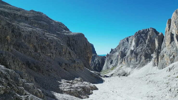 Drone footage of the Pale di San Martino in the Dolomites, Italy: majestic peaks, rocky spires, alpine meadows, and dramatic landscapes ideal for travel, nature, and adventure projects